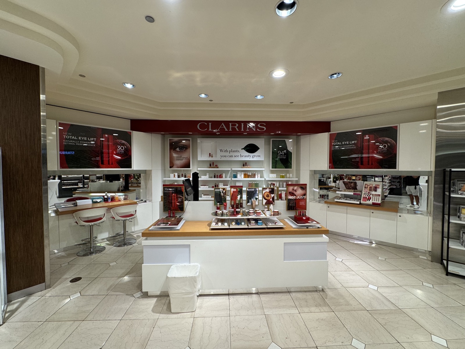 Clarins retail display with branded header signage