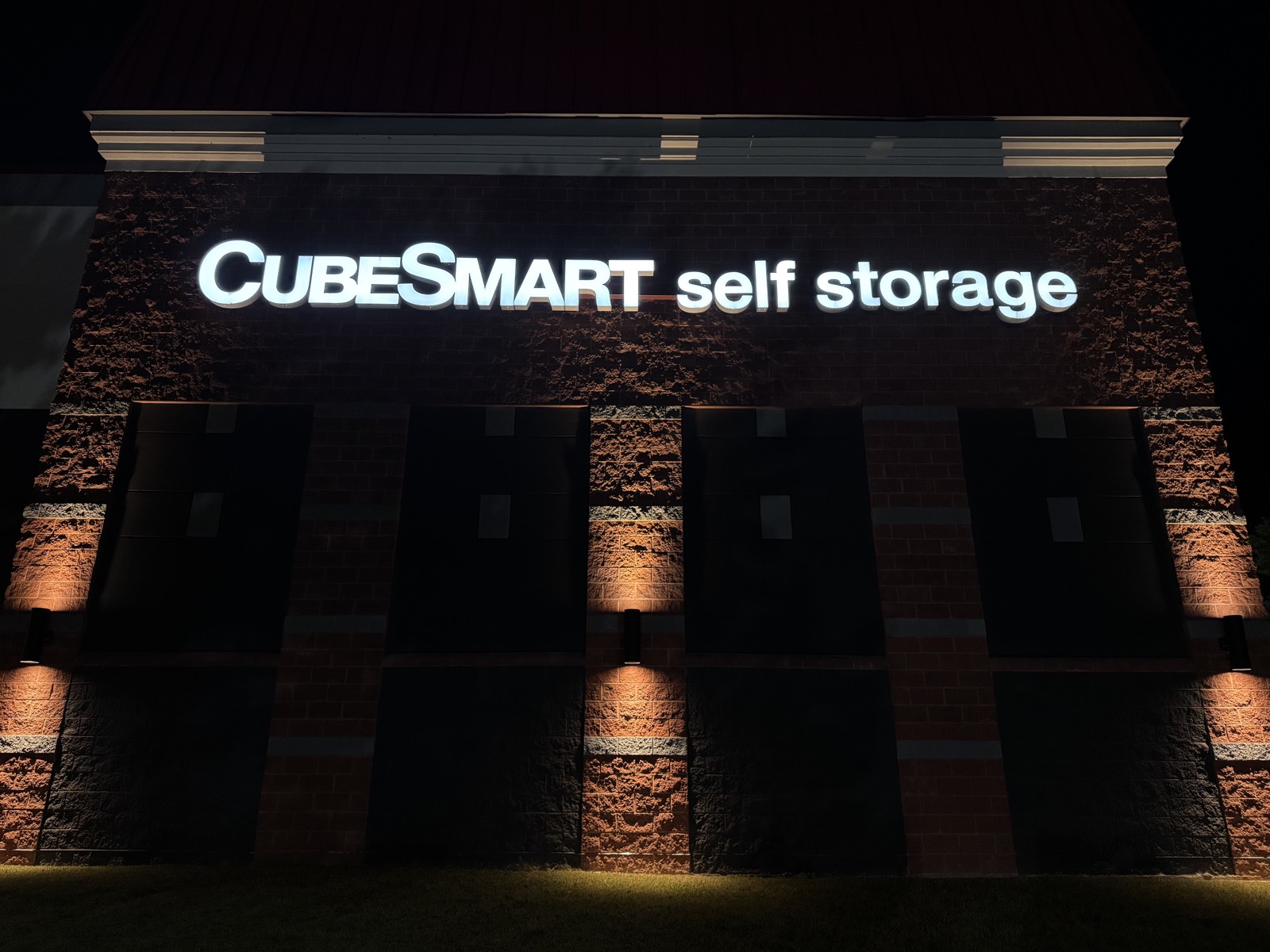 Illuminated channel letters on storage facility facade