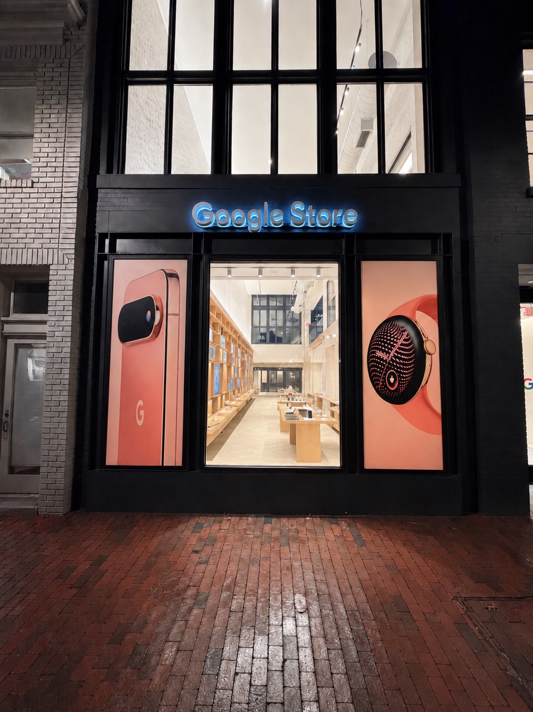 Illuminated channel letters and backlit window graphics on a storefront at night