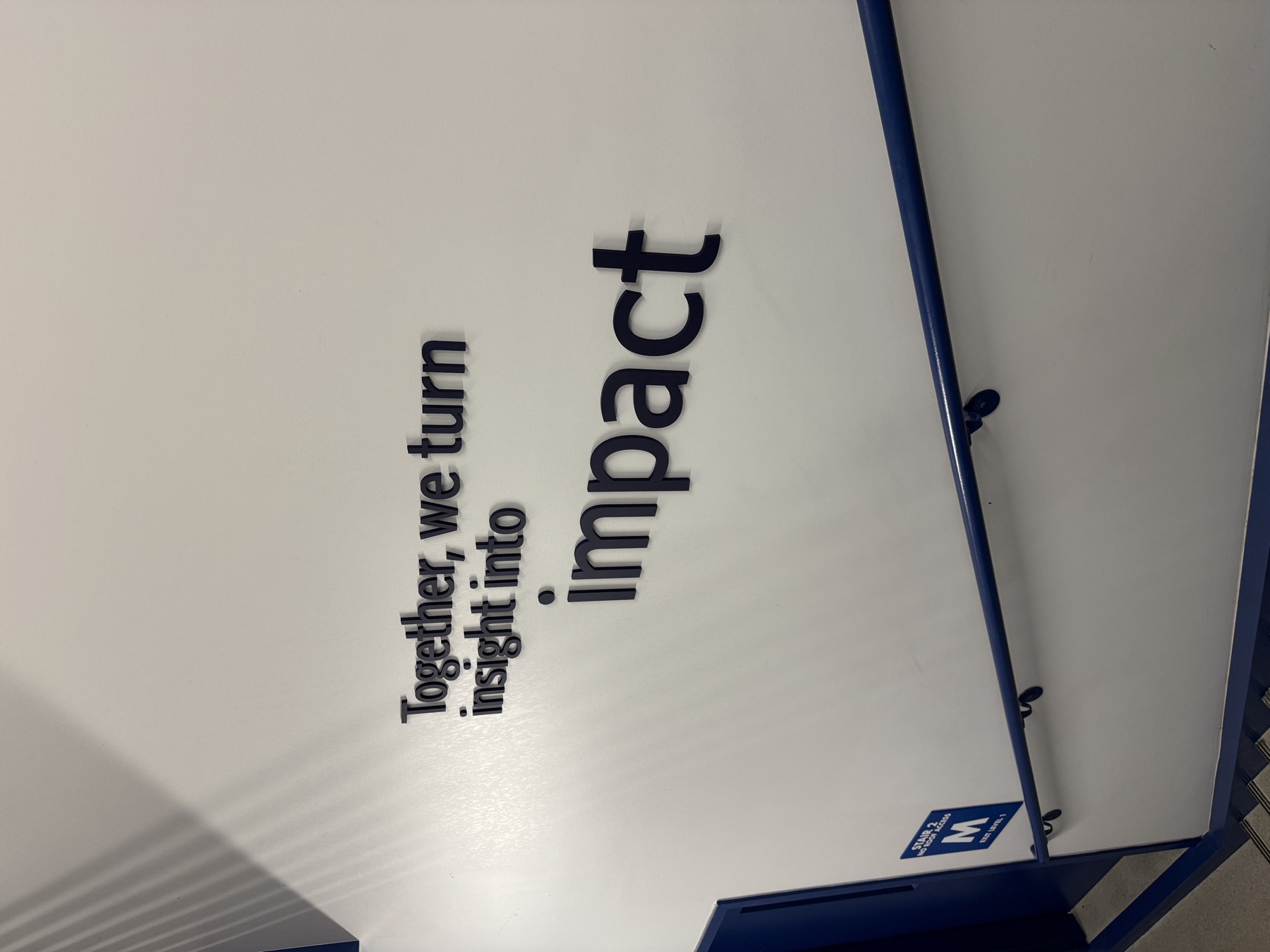 Dimensional 3D lettering installed along an office stairwell wall