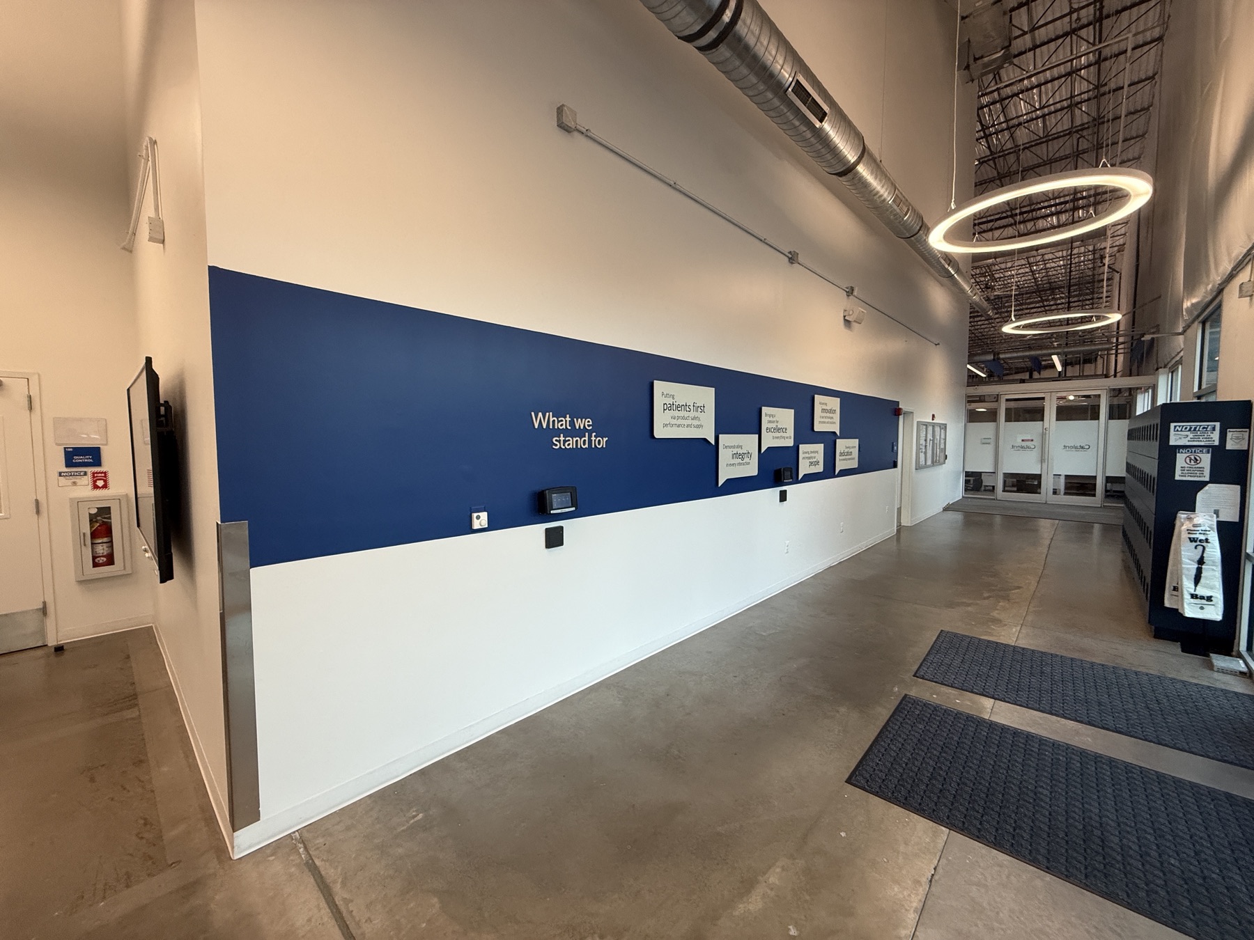 Dimensional lettering and printed message panels along an office corridor