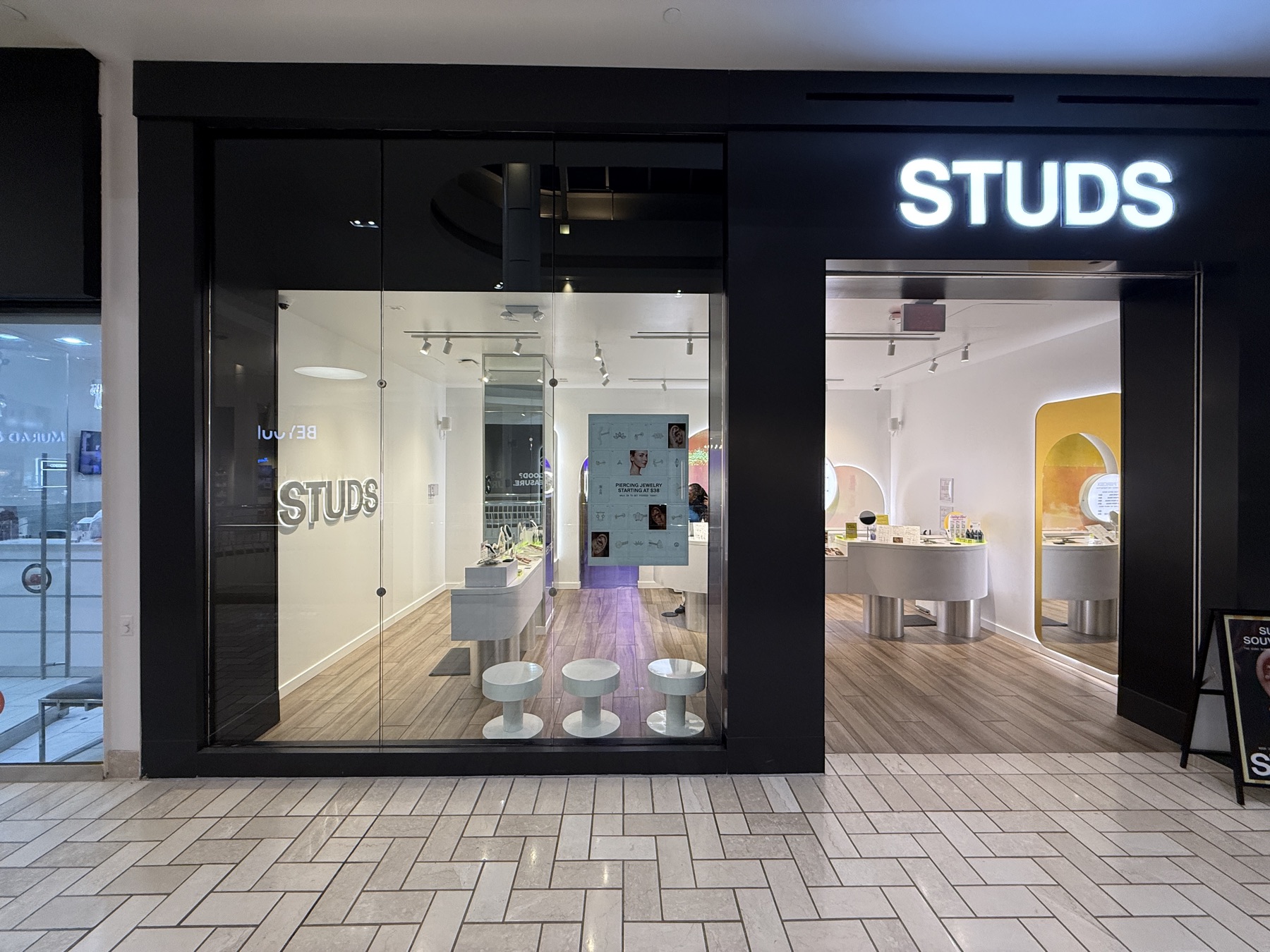 Illuminated storefront letters and interior branding at a retail entrance