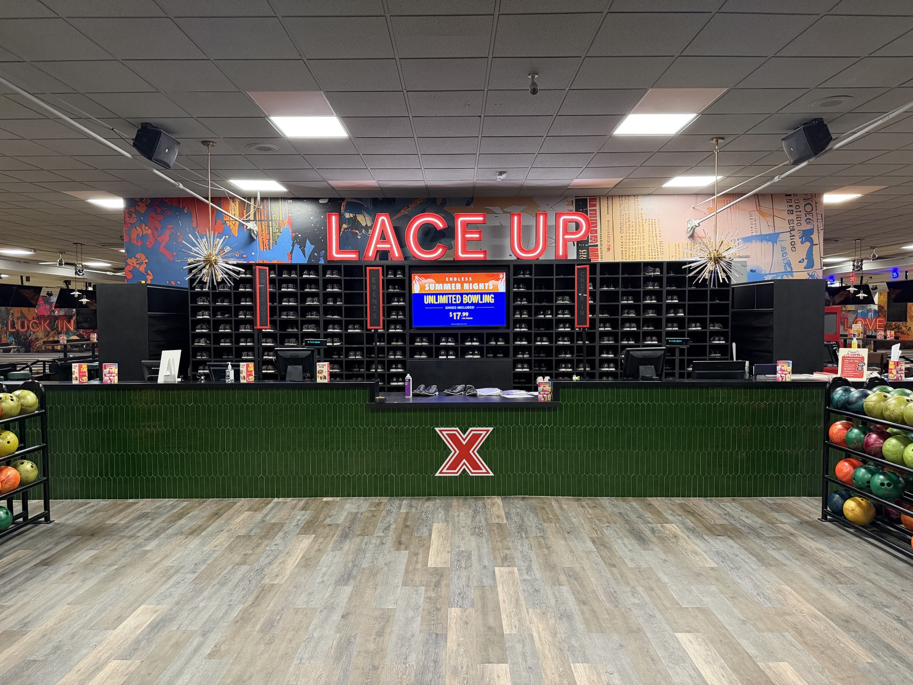 Neon sign and printed backdrop installed at a venue counter