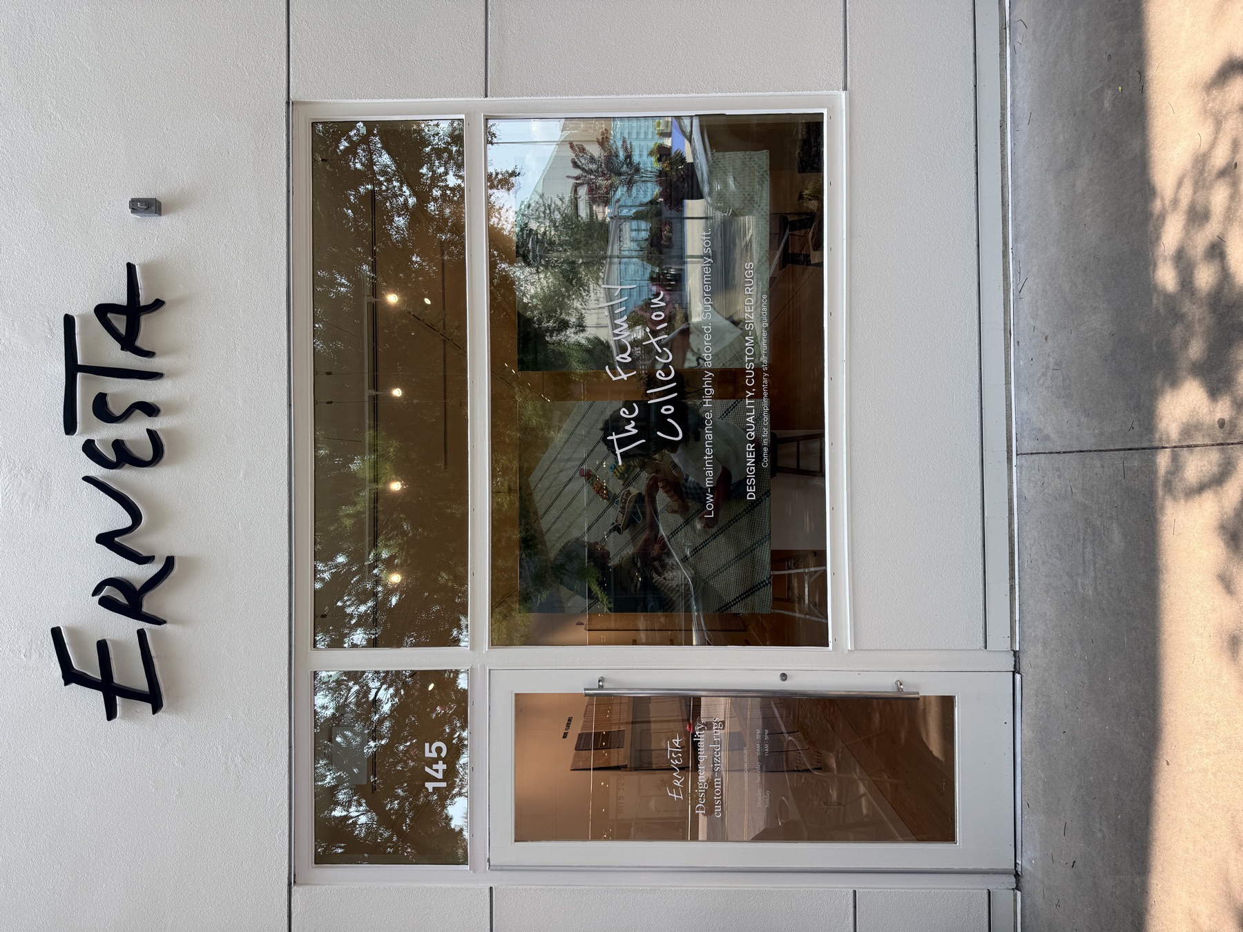 Script dimensional letters and door vinyl on a black storefront facade