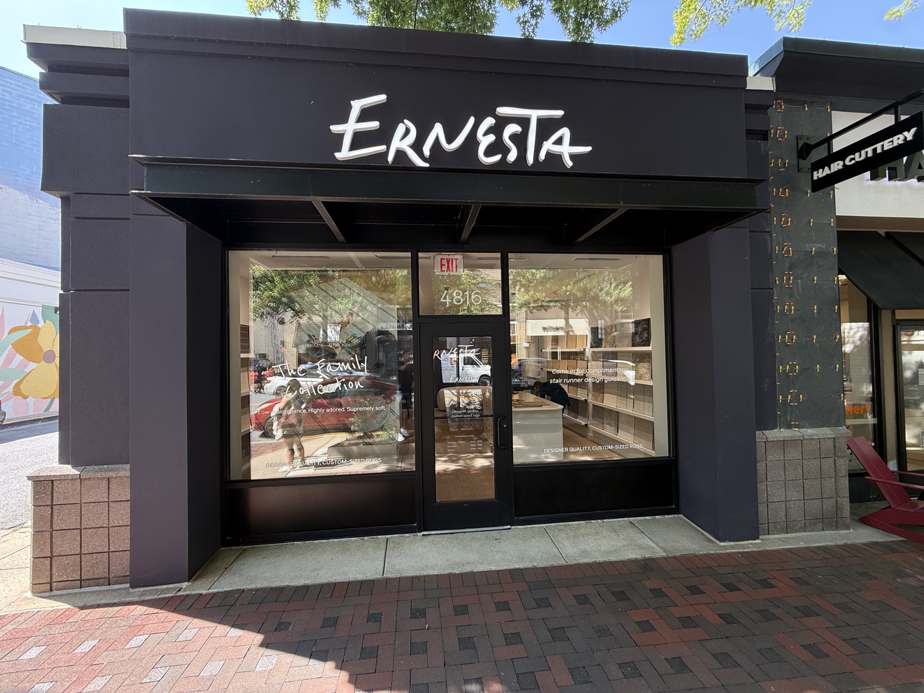 Dimensional script letters installed on a retail storefront fascia