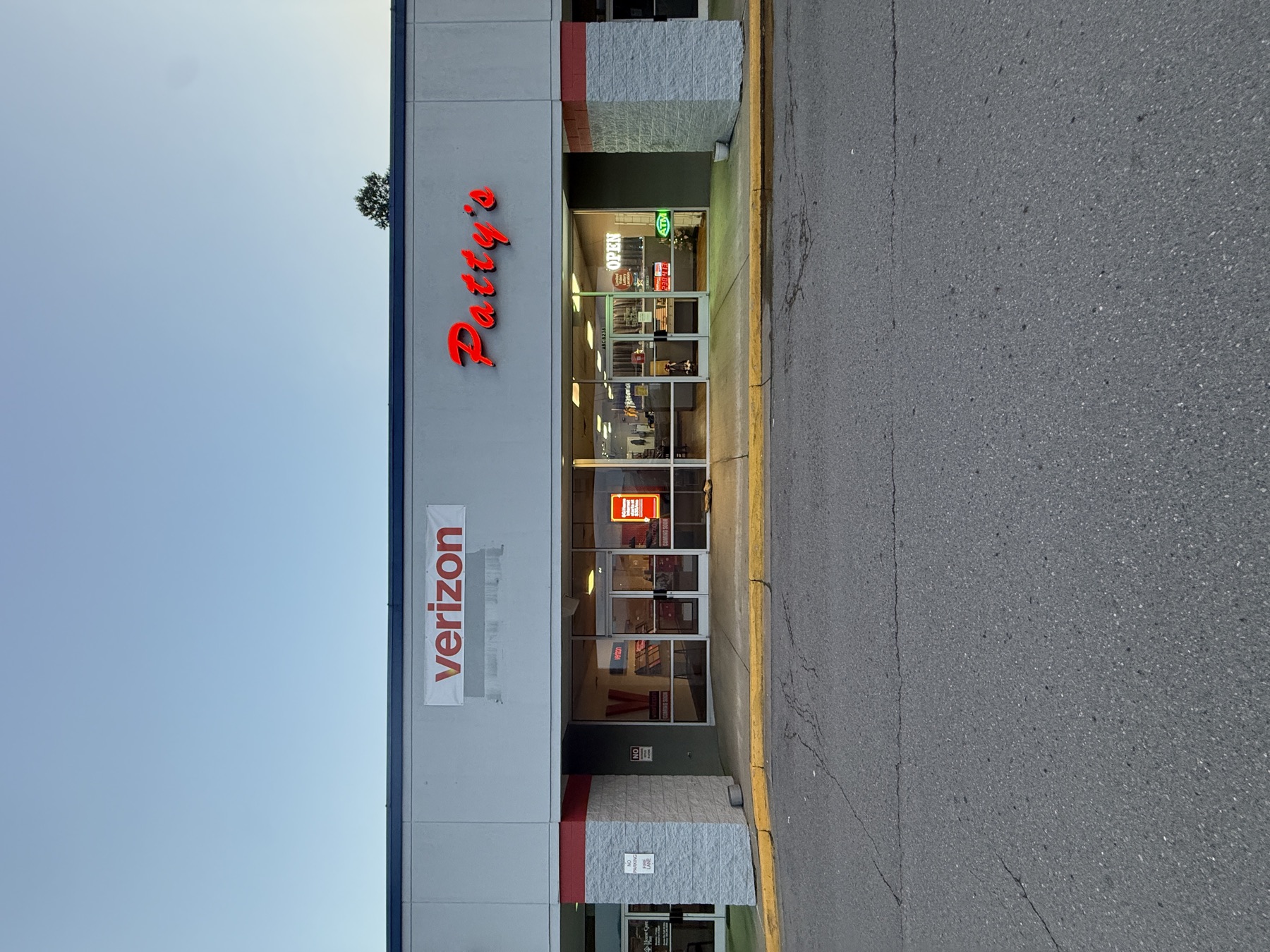 Script channel letters installed on a retail strip facade