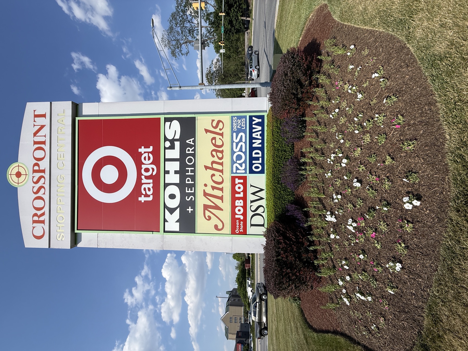 Multi-tenant sign panel lineup at a shopping center