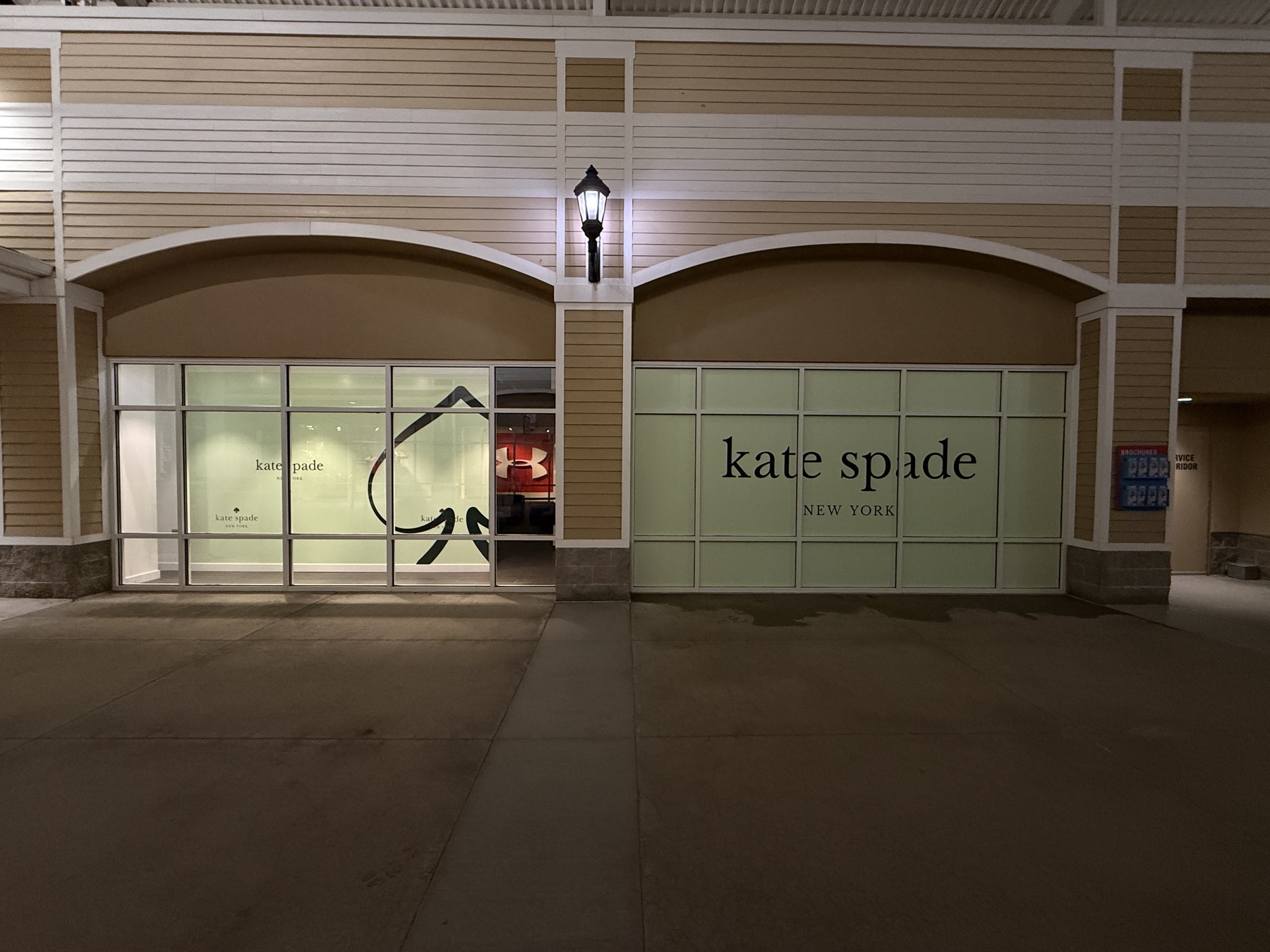 Storefront window vinyl illuminated at night